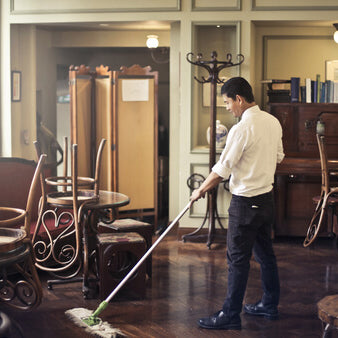 restaurant employee cleanign after work