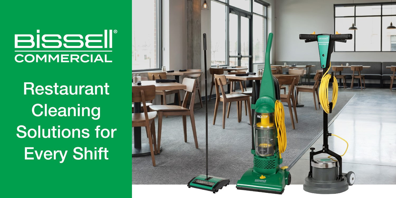 BISSELL Commercial restaurant cleaning equipment, including an upright vacuum, floor sweeper, and floor machine, displayed inside a restaurant dining area.