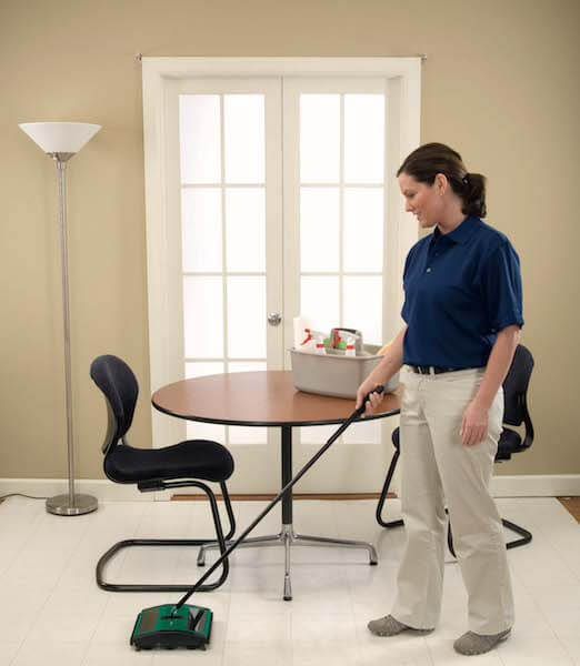 woman using Bissell Vacuum on tile floor