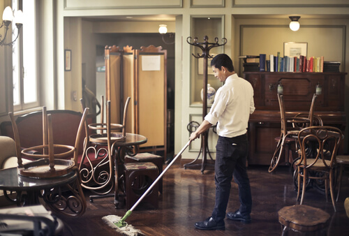 restaurant employee cleanign after work